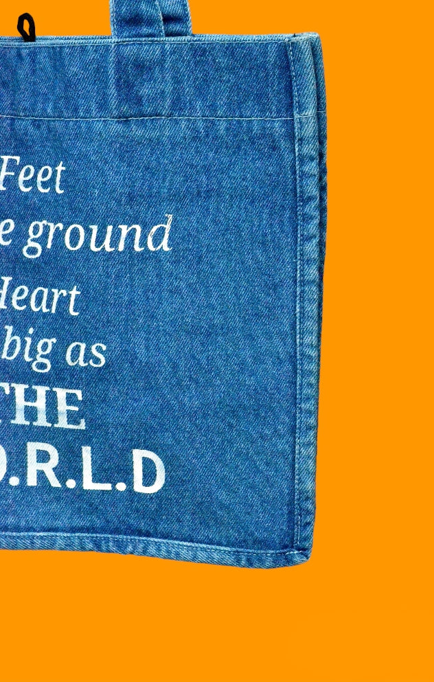 "Feet on the ground, Heart as big as the world" Light Blue Denim Tote bag