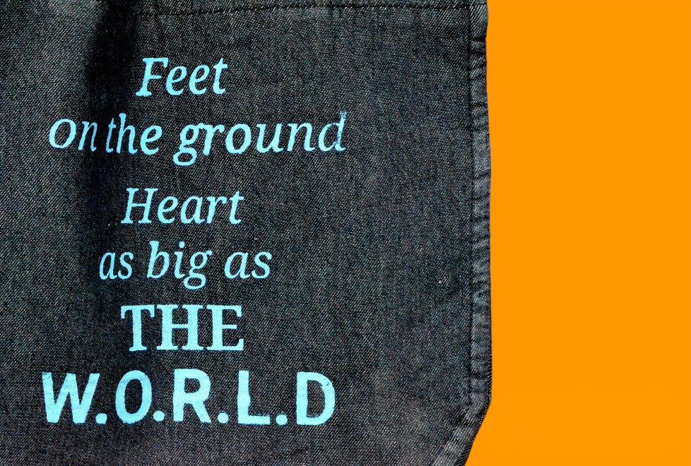 "Feet on the ground heart as big as the world" Black Denim Tote Bag