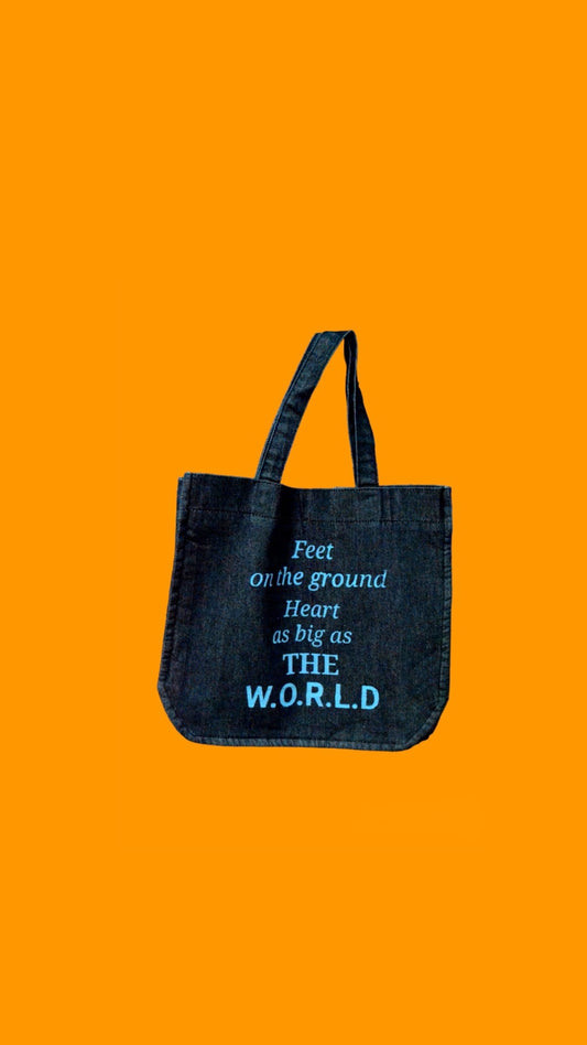 "Feet on the ground heart as big as the world" Black Denim Tote Bag